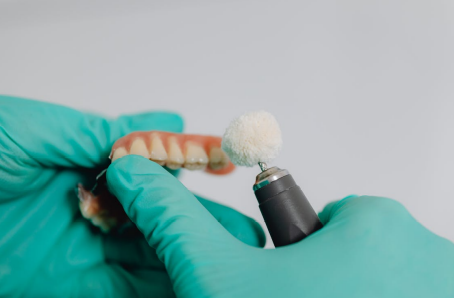 Dentist polishing dental implants during a restorative dental procedure