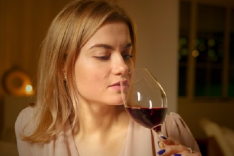 Woman drinking a glass of red wine