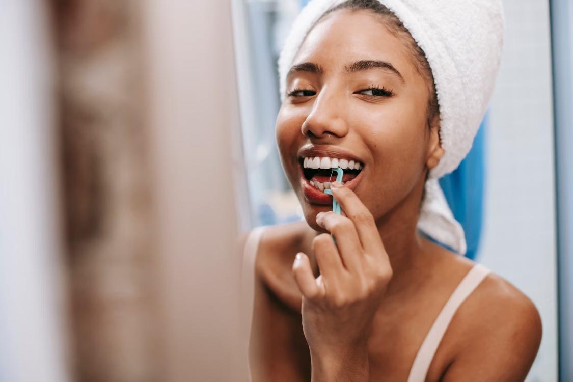 a cheerful woman cleaning her teeth.