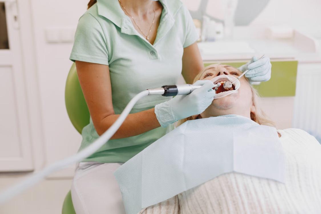 a woman getting a dental treatment.
